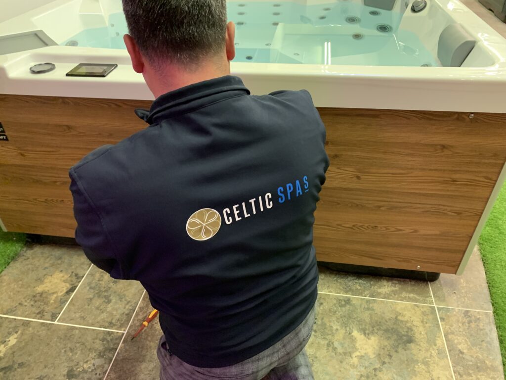 person troubleshooting a hot tub